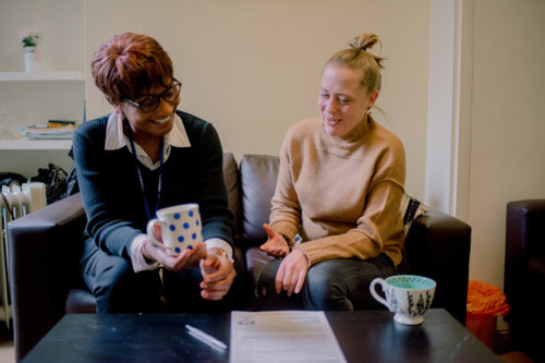 two women chatting over a drink of tea