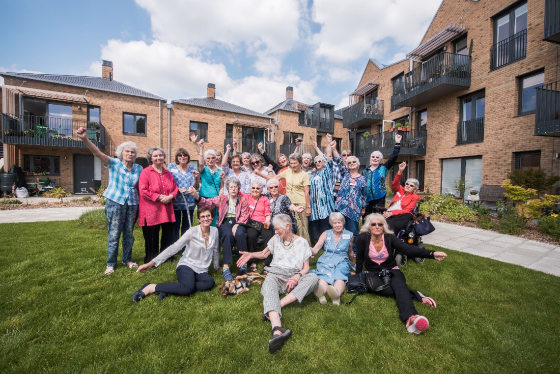 Group of women celebrating outside their housing complex